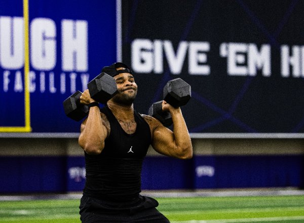 Athlete pressing dumbbells overhead